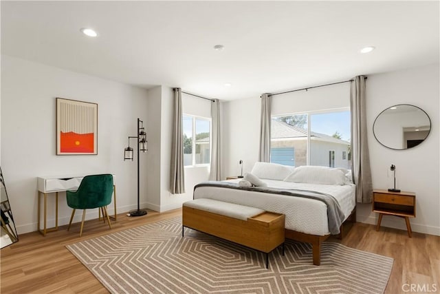 bedroom with recessed lighting, light wood-type flooring, and baseboards