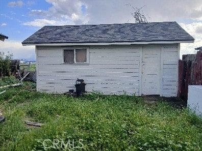 view of outdoor structure featuring fence