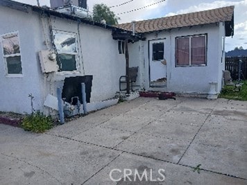 back of property featuring stucco siding