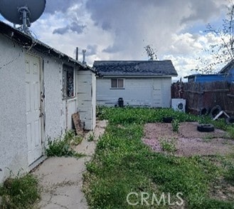 view of side of home with fence