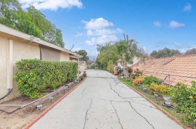 view of street with concrete driveway