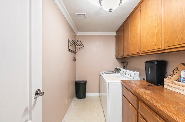 clothes washing area featuring cabinet space, visible vents, ornamental molding, washing machine and dryer, and baseboards