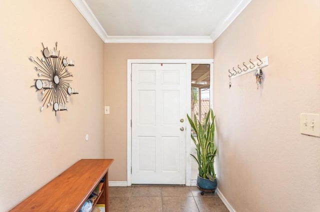 foyer entrance with light tile patterned floors, baseboards, and crown molding