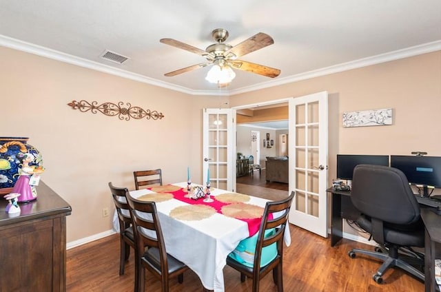 dining space with french doors, crown molding, visible vents, wood finished floors, and baseboards