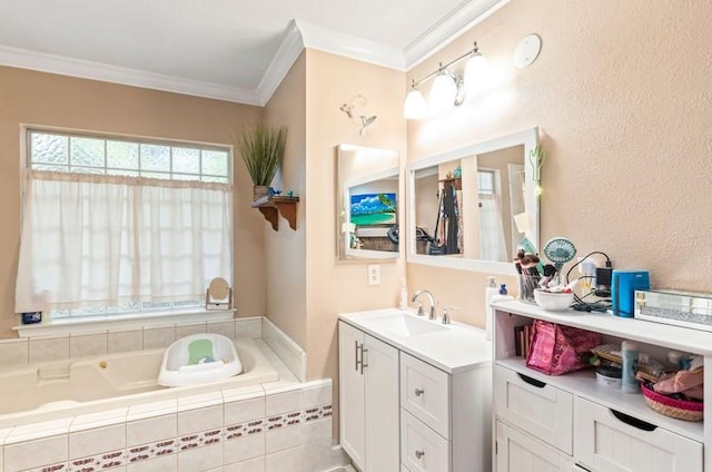 full bathroom with a textured wall, vanity, a bath, and crown molding