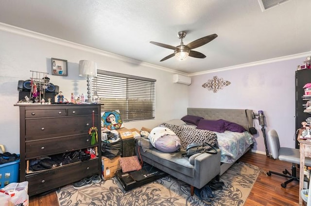 bedroom featuring ceiling fan, wood finished floors, visible vents, a wall mounted AC, and crown molding