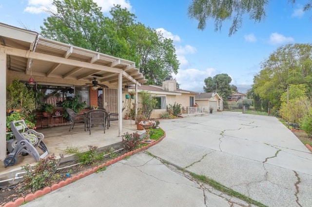 view of patio / terrace with ceiling fan and a pergola