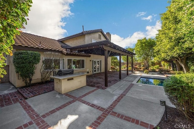 exterior space with an outdoor pool, area for grilling, french doors, and a pergola