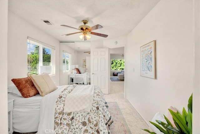 bedroom featuring visible vents, ceiling fan, and carpet