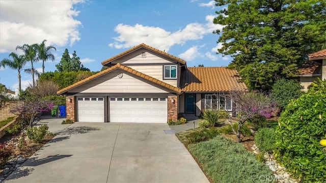 view of front facade with a garage, brick siding, concrete driveway, and a tiled roof