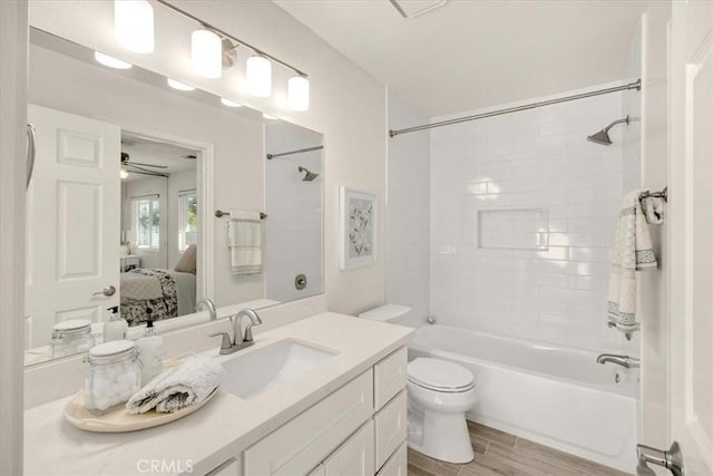 ensuite bathroom featuring shower / washtub combination, toilet, vanity, wood finished floors, and ensuite bath