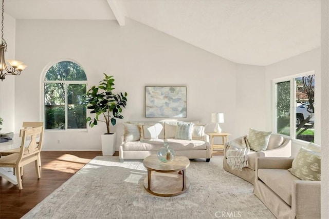 living room with baseboards, an inviting chandelier, wood finished floors, and vaulted ceiling with beams