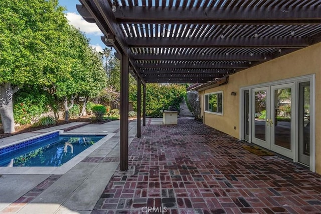 outdoor pool with a patio area, french doors, and a pergola