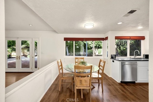 dining space featuring visible vents, recessed lighting, dark wood-style flooring, french doors, and a textured ceiling