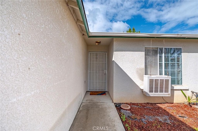 doorway to property with stucco siding