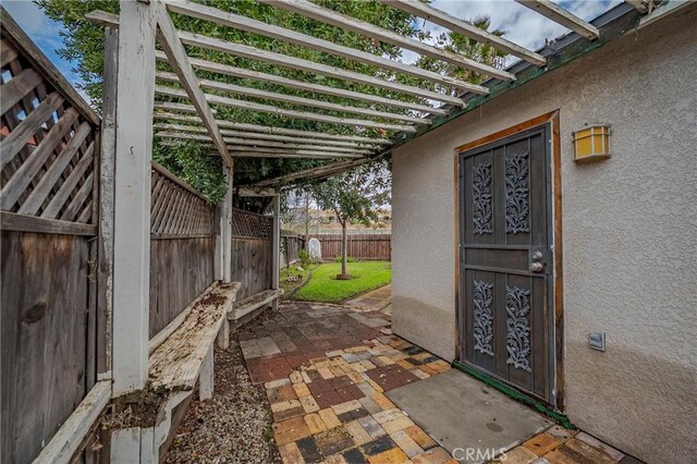 view of patio / terrace featuring fence and a pergola