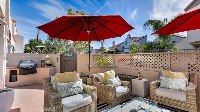 view of patio with a gate, a grill, an outdoor living space, and a fenced backyard