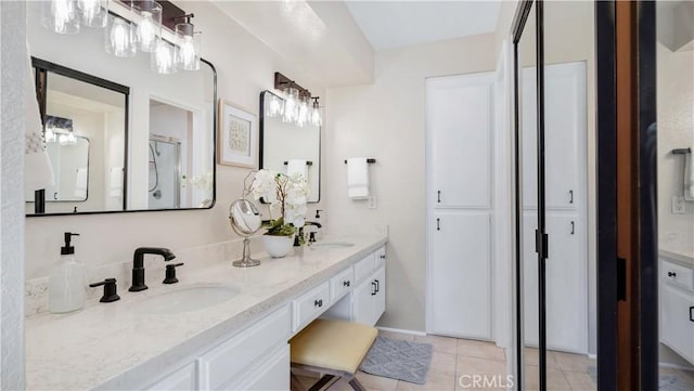 full bathroom featuring tile patterned floors, a sink, and double vanity