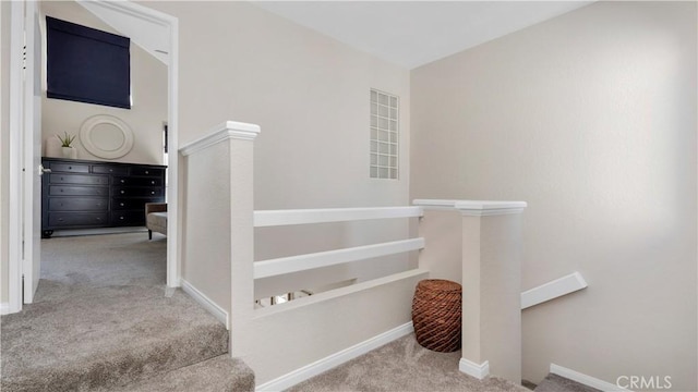 stairs featuring carpet floors and baseboards