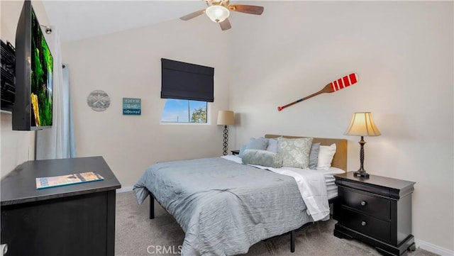 bedroom featuring a ceiling fan, baseboards, lofted ceiling, and carpet