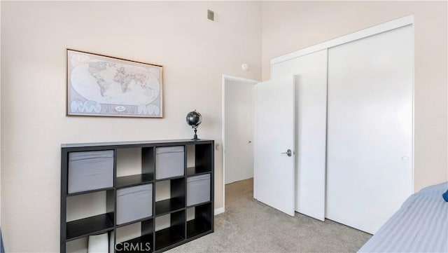 unfurnished bedroom featuring visible vents, carpet, and a closet
