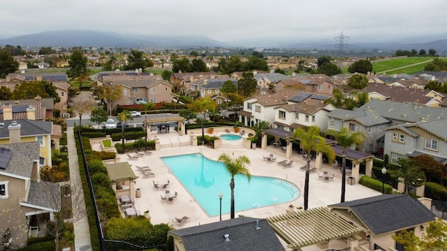 pool featuring a residential view and a patio