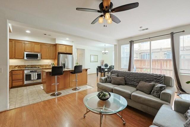1582 Moonbeam Ln, Chula Vista, CA 91915 - living area featuring a chandelier, a ceiling fan, light wood-style flooring, and recessed lighting