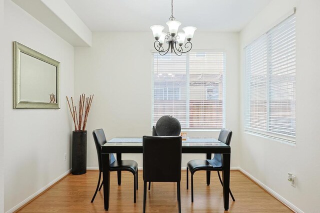 1582 Moonbeam Ln, Chula Vista, CA 91915 - dining area with a chandelier, light wood finished floors, and baseboards