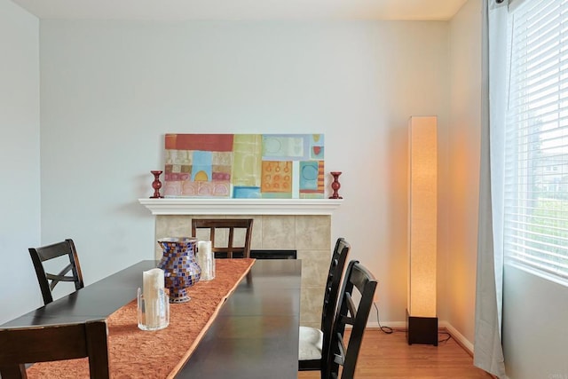 1582 Moonbeam Ln, Chula Vista, CA 91915 - dining area featuring a fireplace, wood finished floors, and baseboards