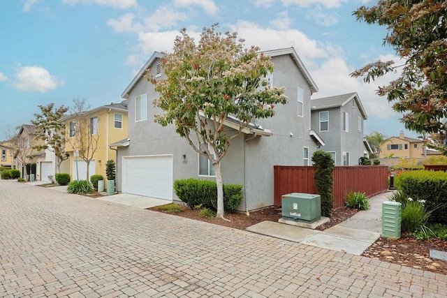 1582 Moonbeam Ln, Chula Vista, CA 91915 - view of front of home with an attached garage, a residential view, stucco siding, and decorative driveway
