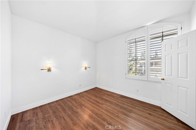 empty room with wood finished floors and baseboards