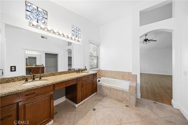 full bath with a ceiling fan, a sink, a bath, and tile patterned floors