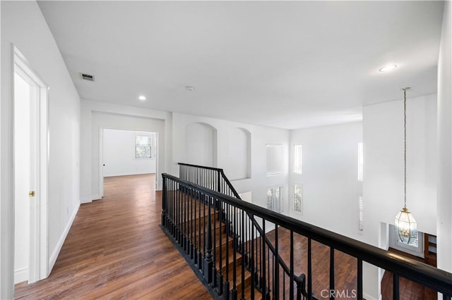 hall with recessed lighting, visible vents, an upstairs landing, wood finished floors, and baseboards