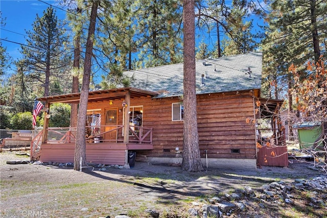 rustic home featuring a shingled roof, crawl space, and a deck