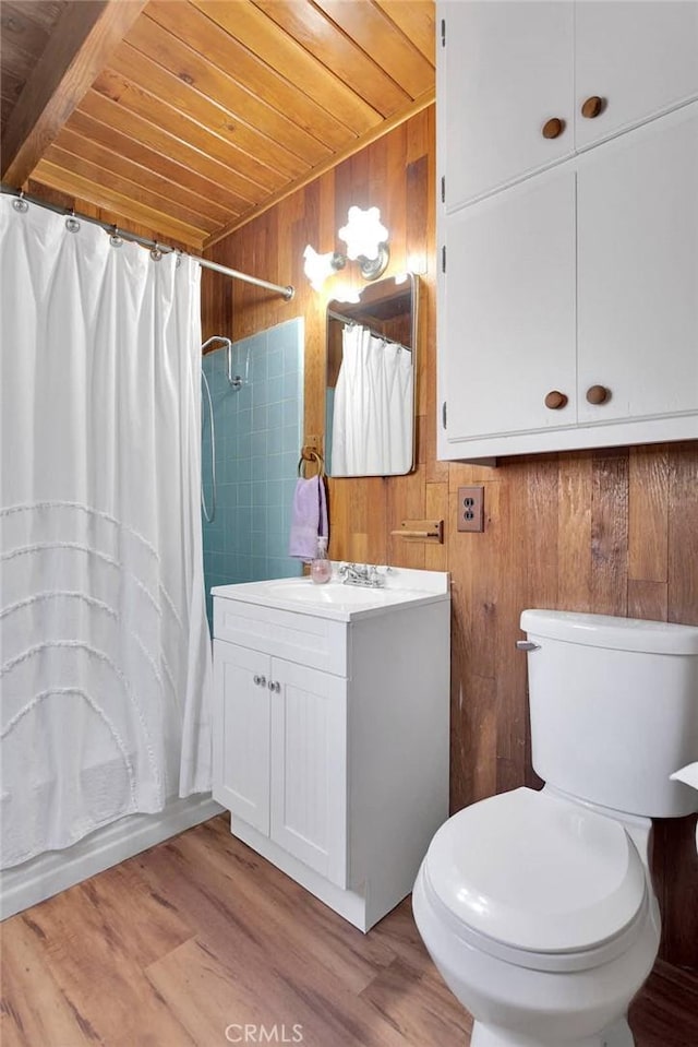 full bath featuring wooden walls, toilet, wooden ceiling, wood finished floors, and vanity