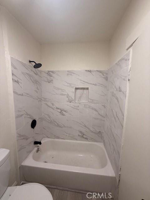 bathroom featuring toilet and shower / bathing tub combination