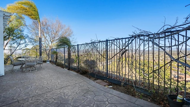 exterior space featuring outdoor dining area and fence