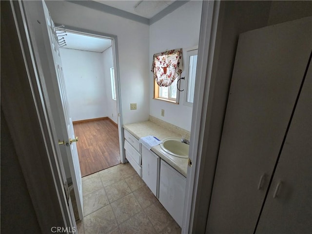 bathroom with vanity and baseboards