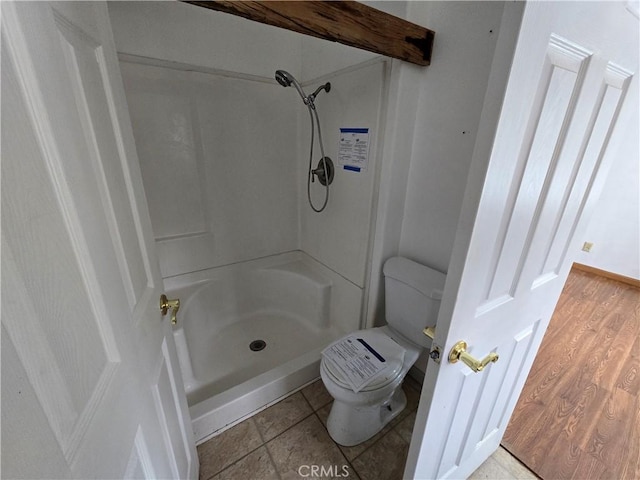 full bathroom with toilet, walk in shower, and wood finished floors