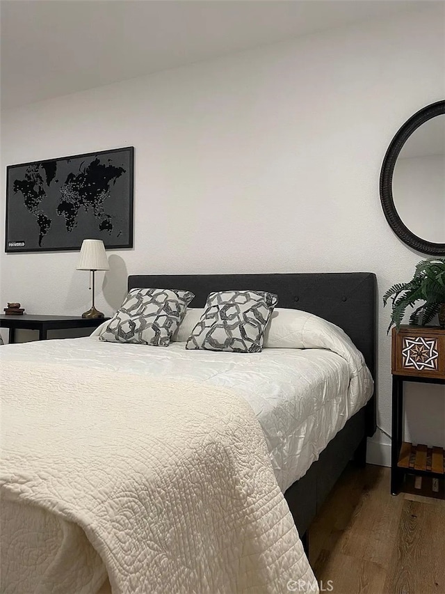 bedroom with wood finished floors