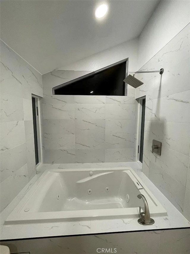 bathroom with a shower and a whirlpool tub