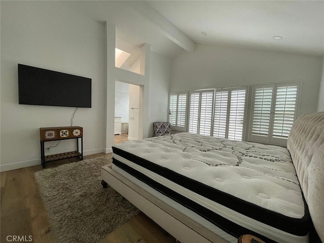 bedroom featuring beam ceiling, high vaulted ceiling, baseboards, and wood finished floors