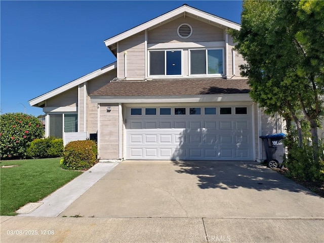 view of front facade featuring concrete driveway, an attached garage, a front yard, and a shingled roof