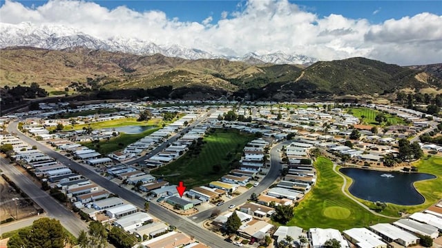 drone / aerial view with a water and mountain view