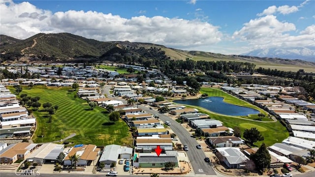 aerial view with a water and mountain view and golf course view