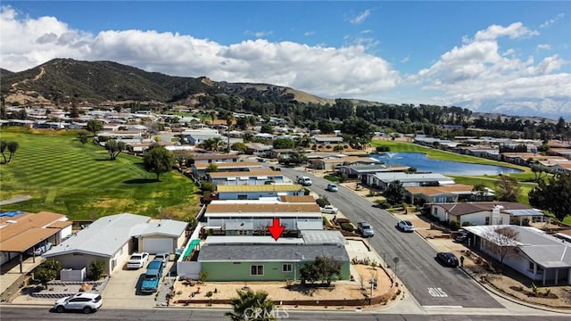 birds eye view of property with a mountain view, a residential view, and golf course view