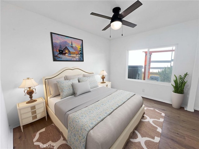 bedroom featuring a ceiling fan, wood finished floors, and baseboards