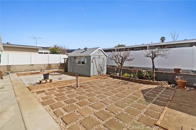 view of patio featuring a fenced backyard, an outdoor structure, and a shed