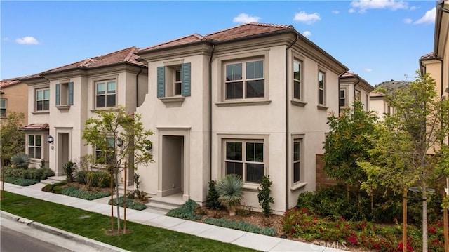 view of front of home featuring stucco siding and a tile roof