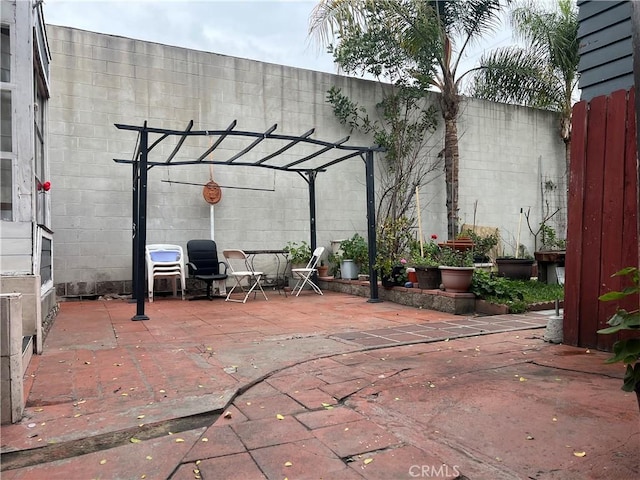 view of patio featuring fence and a pergola